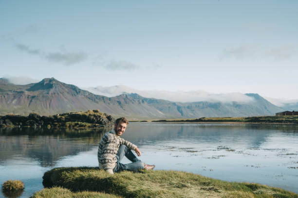istock Man sitting on the beach in Iceland 859242796