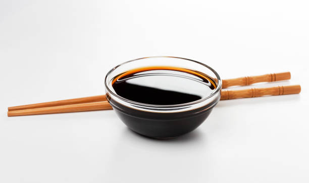 Soy sauce and chopsticks isolated on white background Soy sauce and chopsticks isolated on white background with clipping path soy sauce photos stock pictures, royalty-free photos & images