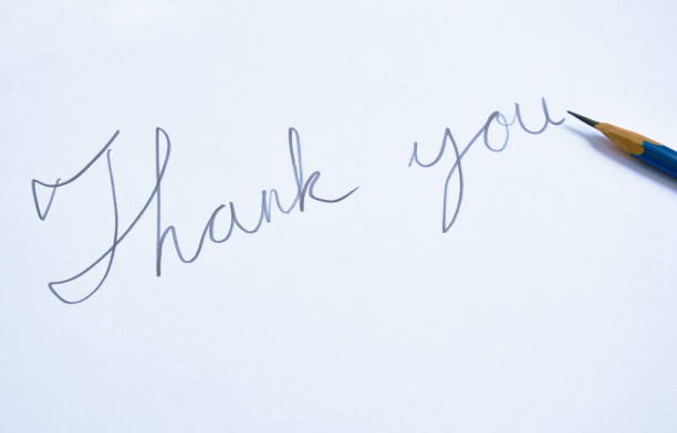istock pencil write thank you on white paper 859244532