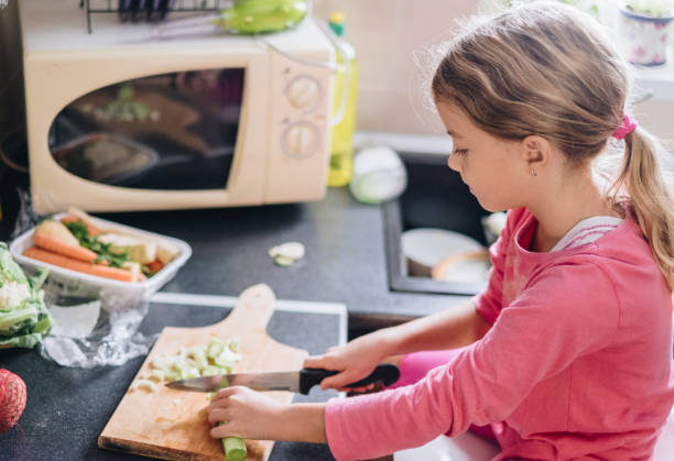 istock Cute girl preparing vegetable for lunch 859250528