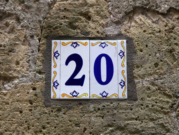 House number twenty (20): ceramic tiles with blue figures on old stone wall. House number twenty (20): ceramic tiles with blue figures on old stone wall. Traditional Italian home sign board painted on ceramic tile ceramic tile house numbers stock pictures, royalty-free photos & images