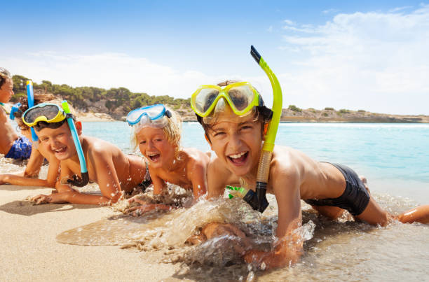 istock Happy screaming boys in scuba mask on the beach 859254024
