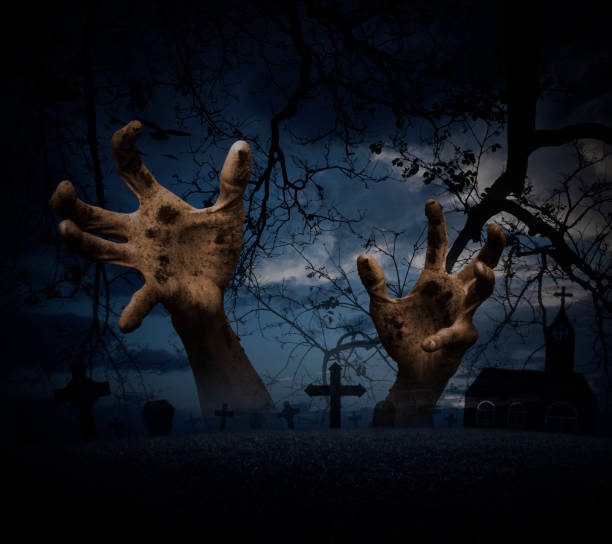 istock Zombie hand rising out from grass over cross, dead tree, moon and church 859258512