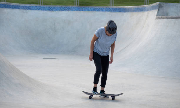 istock An active senior woman trying on stand up on skateboard. 859258870