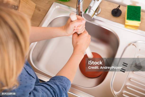 Woman Using Plunger In Sink Stock Photo - Download Image Now - Clogged,  Kitchen Sink, Sink - iStock