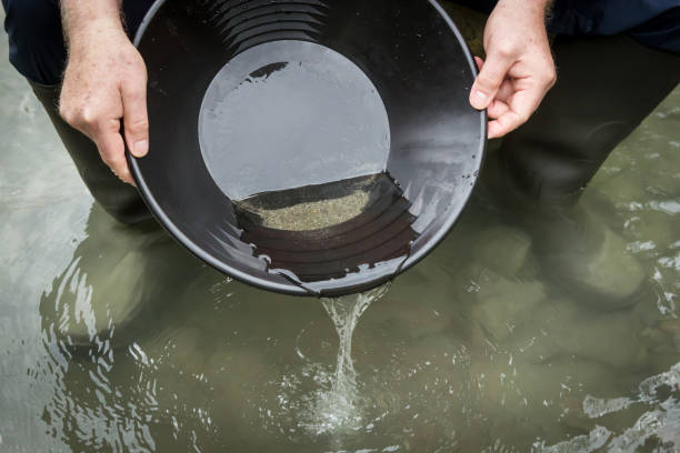 istock a gold pan with water and sand in it 859258952