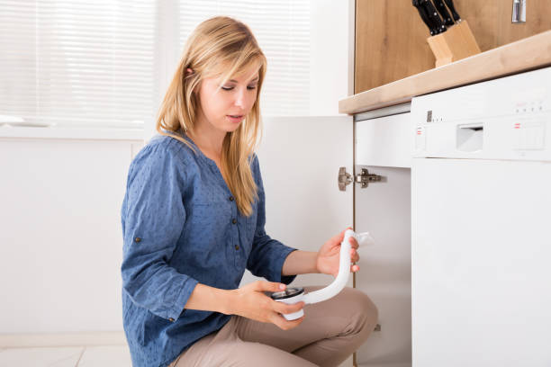 istock Woman Holding Sink Pipe In Kitchen 859259038