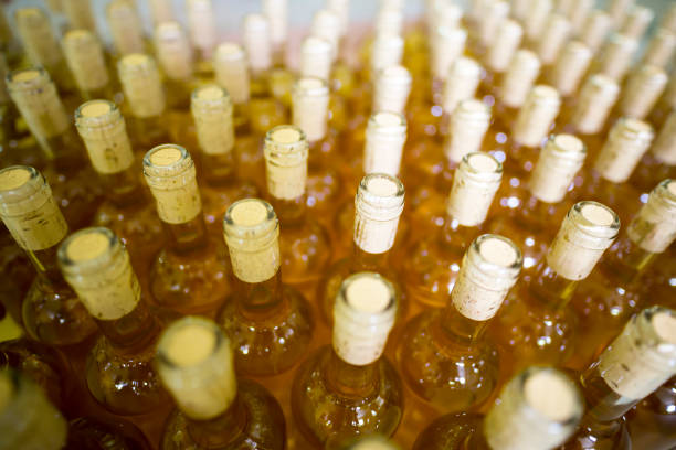 White wine bottles in a winery White wine bottles in a winery ordered for labeling before packed and shipped for sale. wine shipping stock pictures, royalty-free photos & images