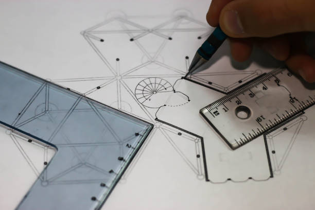 Architect draws for construction plans with pencil and rulers