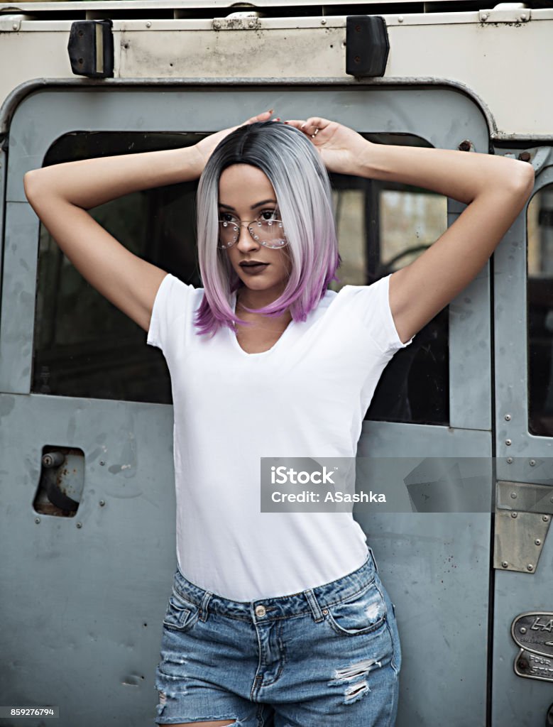 Fashionable young woman with bob hair Attractive woman with sunglasses posing T-Shirt Stock Photo