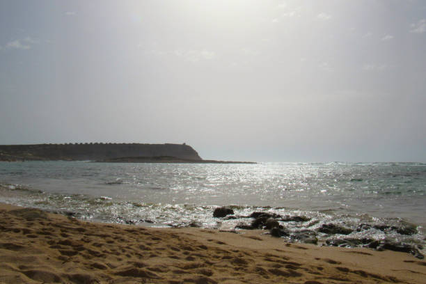 August sunshine reflections on the sea of Sa Mesa Longa beach in the afternoon (Oristano - Sardinia)