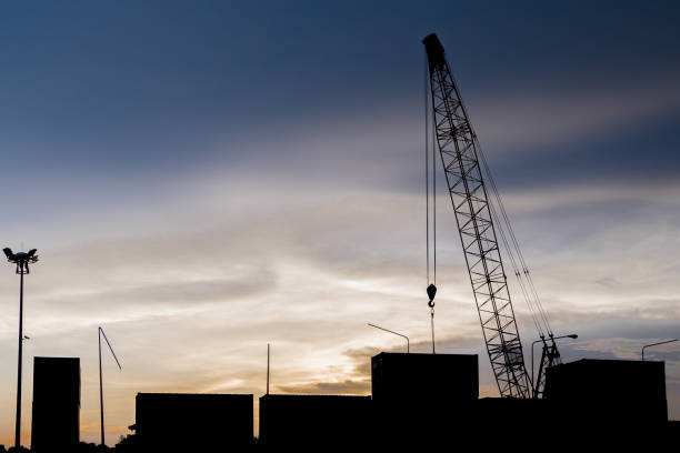 istock Crane transport container docks area silhouette with sunset background. 859285106