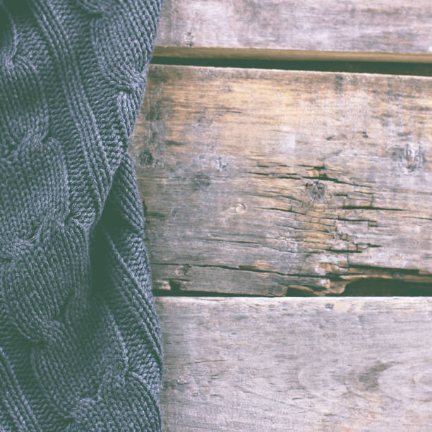 knitted plaid, sweater on old wooden boards