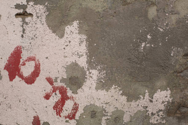 istock Old crumbling paint on gray plaster concrete wall texture 859289212