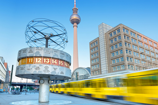 Berlin, Germany - September 18, 2014 : Alexanderplatz in Berlin in the morning with train passing by. On the left the Weltzeituhr ( World Clock ) is an astronomical clock installation located in Alexanderplatz, Berlin - behind the television tower.