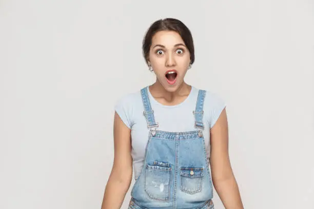 Photo of Wow! Portrait of  cute woman with shocked facial expression.