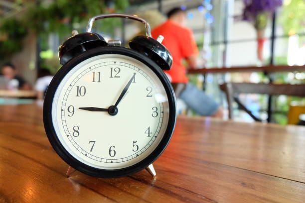 breakfast waffle,sausage with alarm clock on wooden table