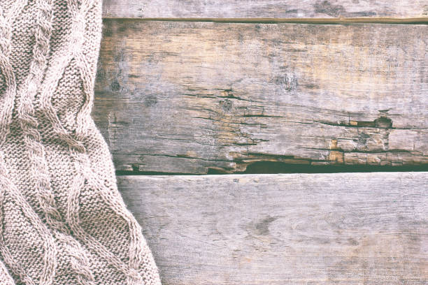 istock knitted plaid, sweater on old wooden boards 859296058