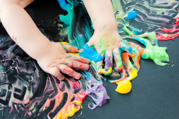 istock baby painting with his hands 859299352