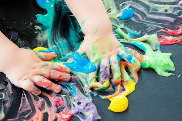 istock baby painting with his hands 859299428