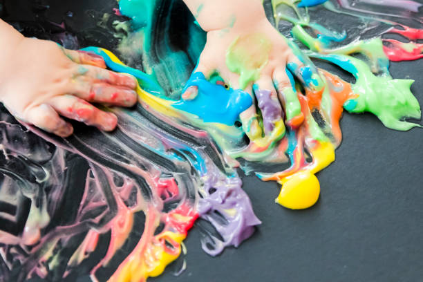 istock baby painting with his hands 859299488