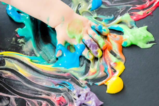 istock baby painting with his hands 859299556