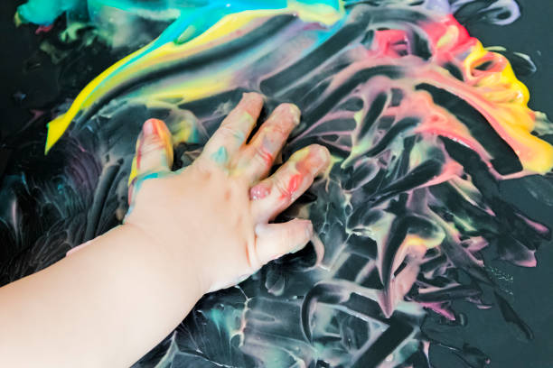 istock baby painting with his hands 859300122
