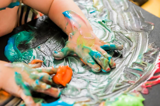 istock baby painting with his hands 859300374