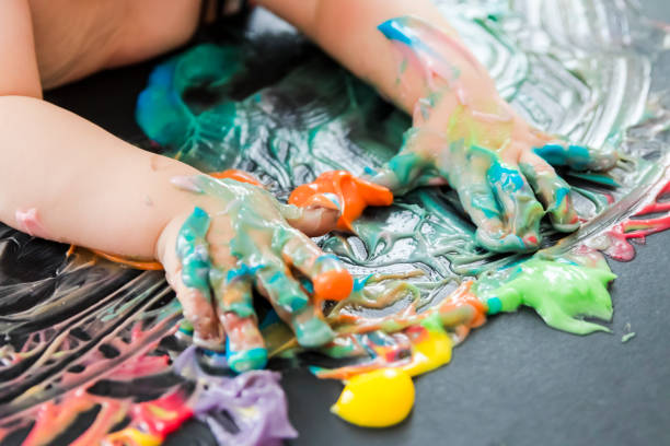 istock baby painting with his hands 859302564