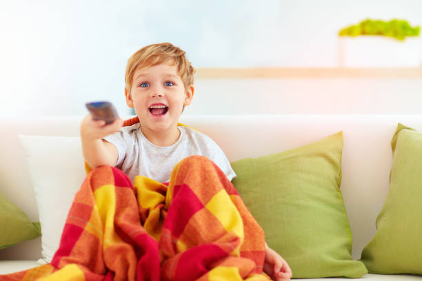 istock excited boy, kid watching tv at home 859304200