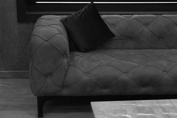 sofa and backrest pillow Black and white image of vintage sofa with backrest pillow in room. backrest stock pictures, royalty-free photos & images