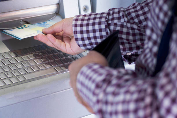 istock man using cash machine, taking euro in cash from atm 859308070