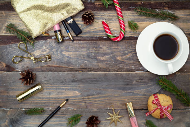 istock Cosmetics for make-up and New Year decorations on a wooden background. Copy space 859308248