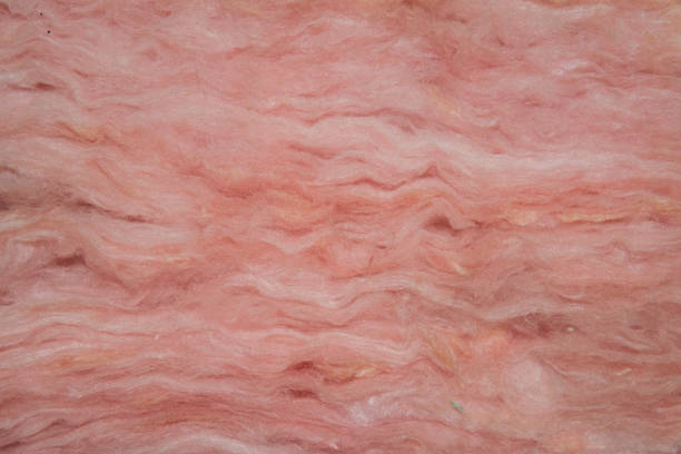 Pink Insulation Closeup view of layers of pink fiberglass insulation. fibreglass stock pictures, royalty-free photos & images