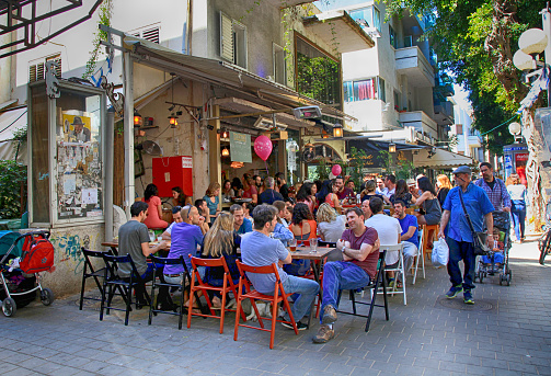 TEL AVIV, ISRAEL - APRIL 1, 2016: People in outdoor cafe on Dizengoff Street in Tel Aviv, Israel.