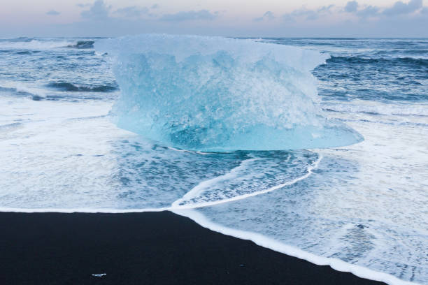 istock Natural freezing iceberg over black sand beach 859315750