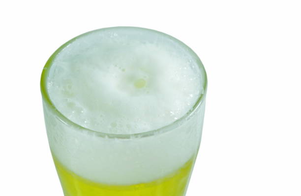 cold beer with frothy in glass on white background