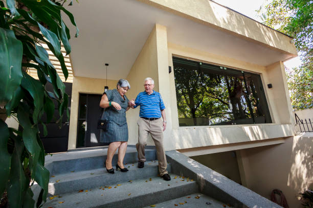Elderly couple walking down stairs