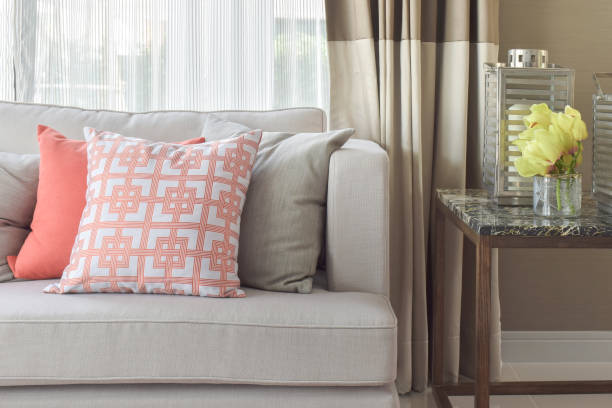 istock Chinese pattern  in orange and deep orange and gray pillows on light gray sofa  with marble top table 859322340