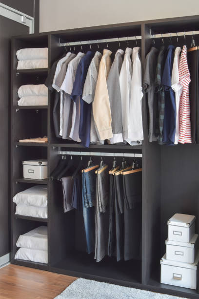 istock modern closet with row of cloths hanging in black wardrobe 859322814
