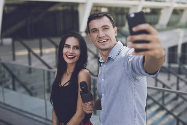 istock A journalist makes a selfie with a girl 859325612