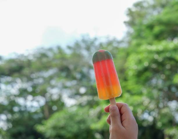 colorful ice cream in hand green background