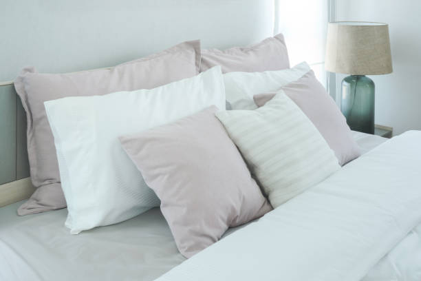 istock Pink pillows on bed in modern bedroom interior 859328892