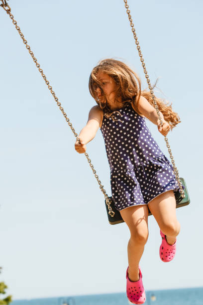 istock Girl swinging on swing-set. 859329246