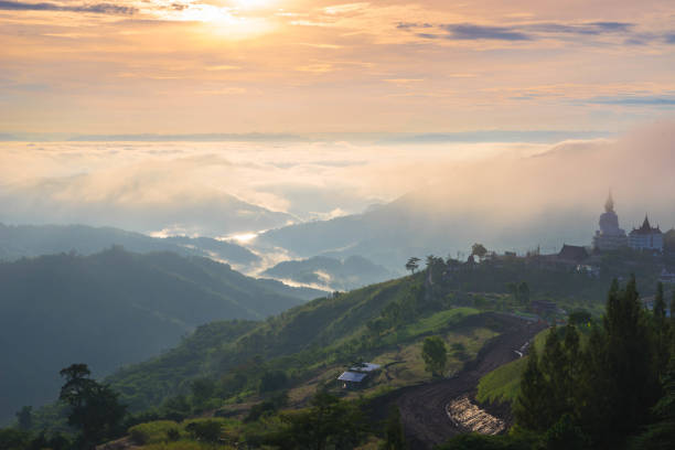 istock Panorama view of mountain range, temple and Buddha statue in the mist under sunset 859335814