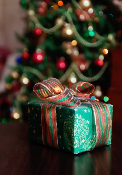 istock Gifts under the Christmas tree lights background 859336626