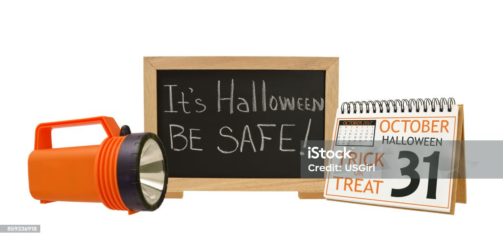 It's Halloween Be Safe! Blackboard It's Halloween Be Safe! Flashlight Calendar white background Safety Stock Photo