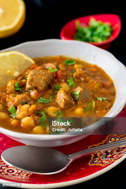 Regional Food Backgrounds Famous Moroccan Soup Harira With Meat Chickpeas Lentils Tomatoes And Spices Dark Vertical Photo Stock Photo - Download Image Now