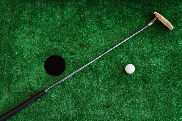istock Close up. Office golf. Golf club and golf ball on a miniature golf course 859343376