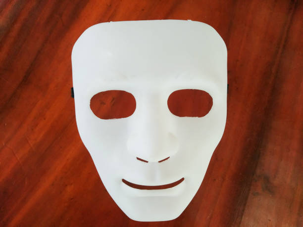 istock the white mask on wooden background 859347478